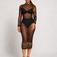 Luxury black sheer mesh midi dress with green and gold beaded embellishments, long sleeves, mock neckline, and fitted silhouette by Marlene Simone.