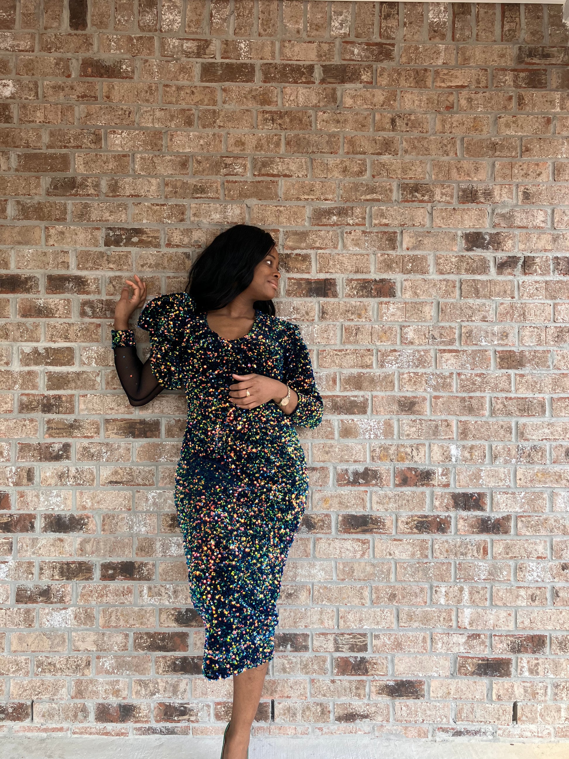 Elegant V-neck midi sequins dress featuring asymmetrical sheer sleeve detailing, tailored silhouette, and sophisticated design by Marlene Simone.